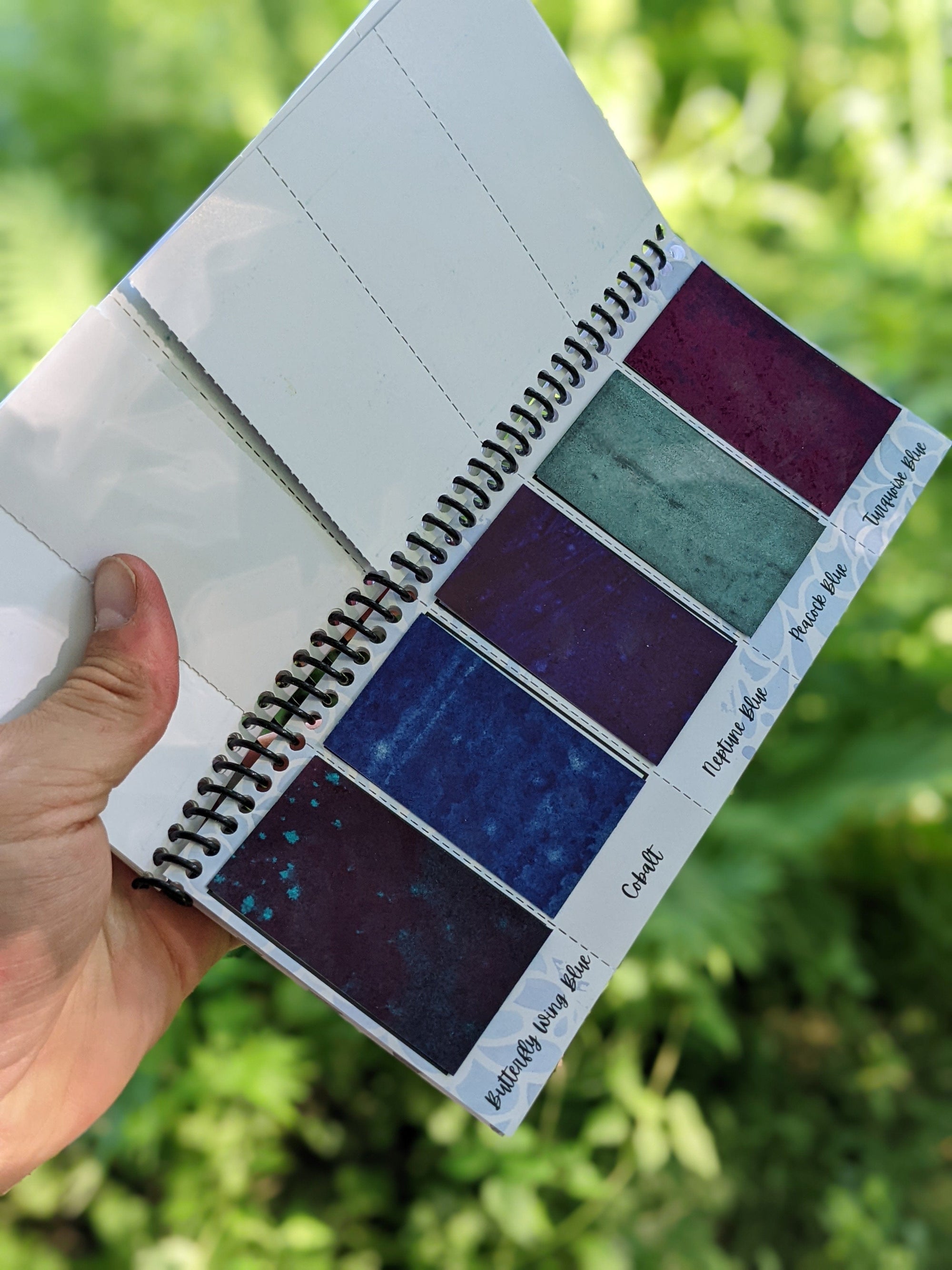 inside sheet of the peerless watercolors portable watercolor palette the Sidekick. This watercolor palette is super vibrant, portable, and easy to use.  this picture is showing of the blue paints included in the travel watercolor palette.