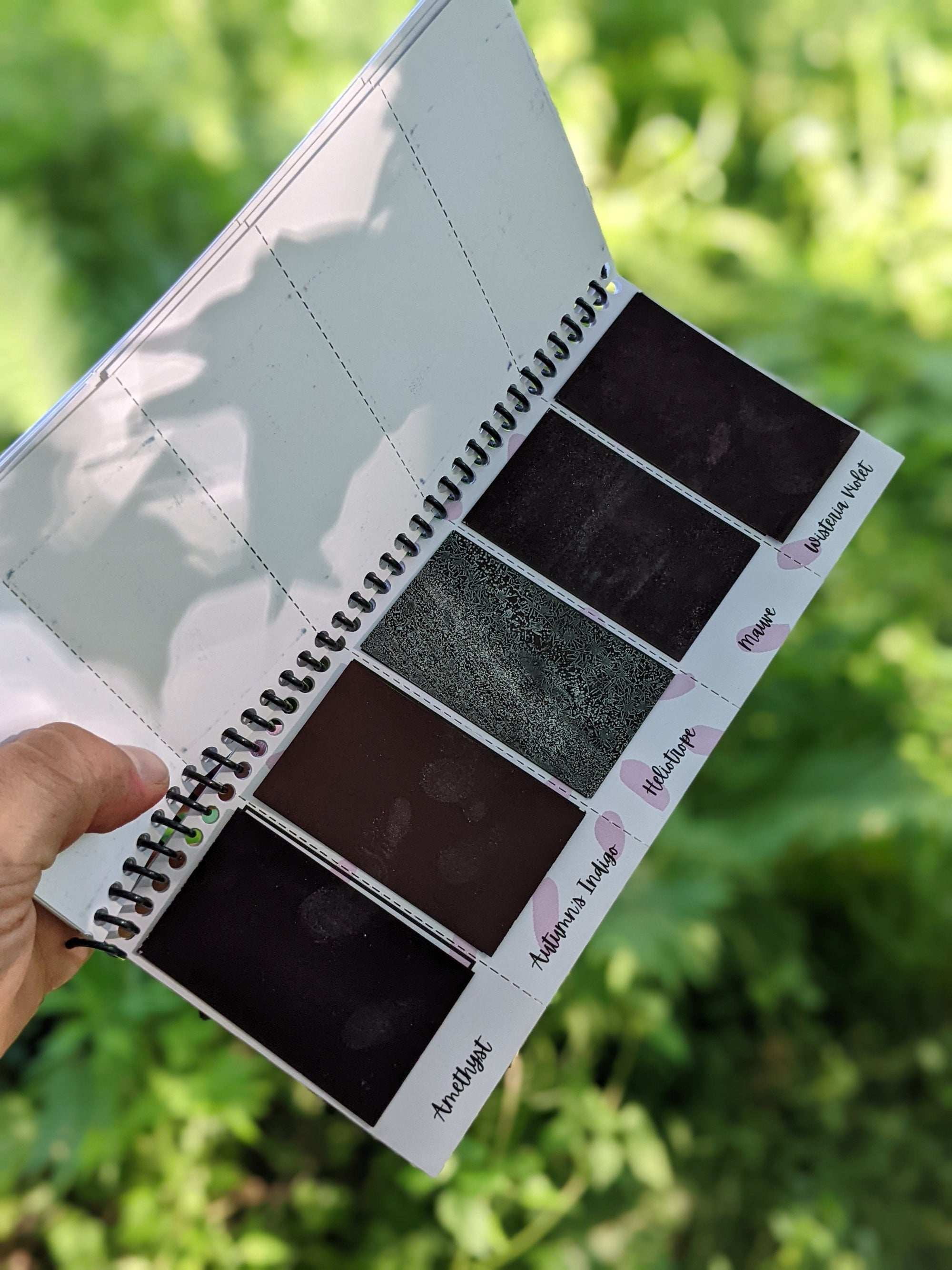 inside sheet of the peerless watercolors portable watercolor palette the Sidekick. This watercolor palette is super vibrant, portable, and easy to use.  this picture is showing of the purple and indigo paints included in the travel watercolor palette.