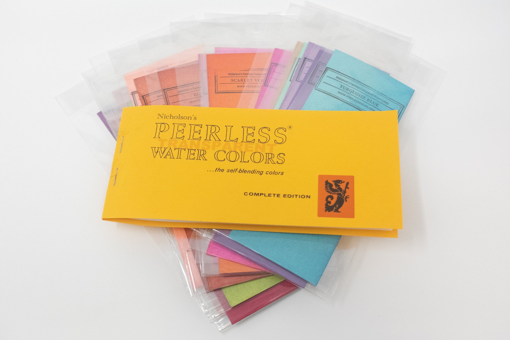 full profile view of the original complete edition. This is the first travel watercolor palette peerless watercolors ever created and it still is one of our best sellers to this very day. The 15 watercolors included are non-toxic, vibrant, and easy to use. show with various single peerless drycolor watercolor sheets.