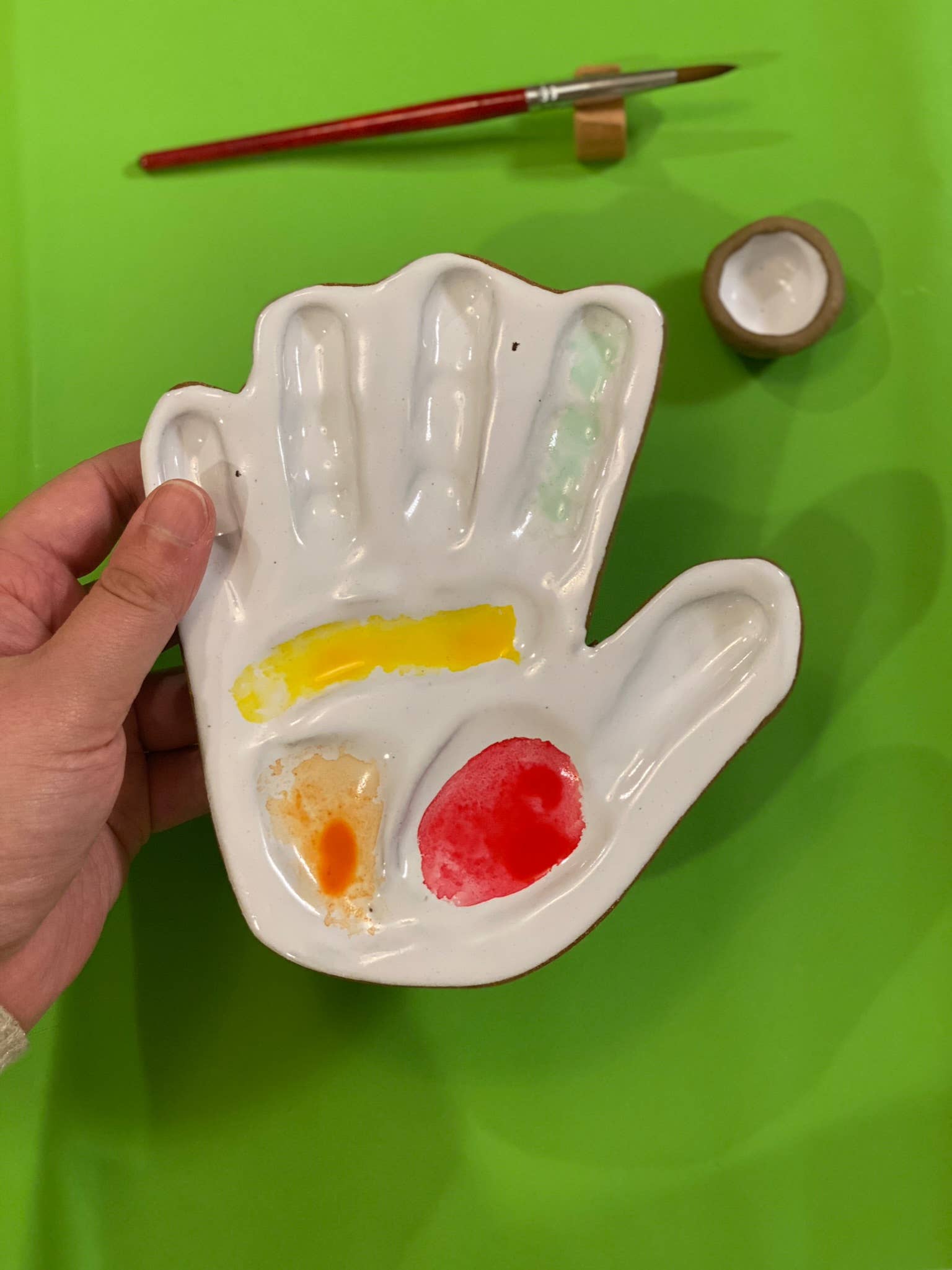 hand made, ceramic palette, modeled after the hand of the artist that made the watercolor mixing palette