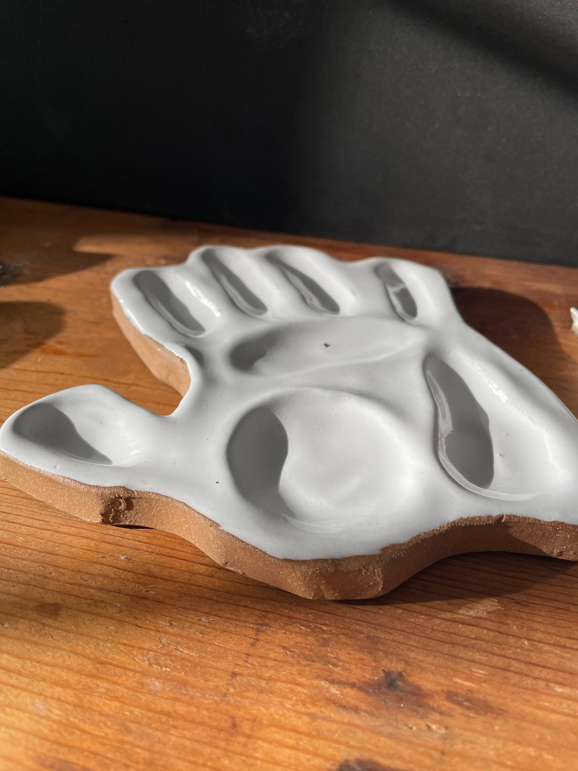 hand made, ceramic palette, modeled after the hand of the artist that made the watercolor mixing palette