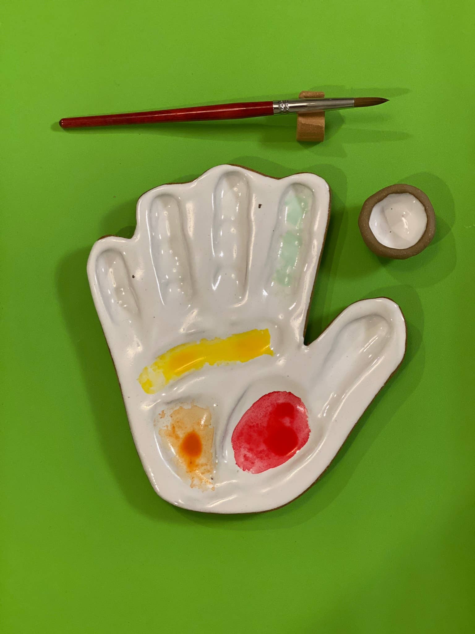 hand made, ceramic palette, modeled after the hand of the artist that made the watercolor mixing palette